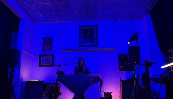 Laura Burhenn of The Mynabirds plays the keyboard and sings at an Undertow Show. Her dog, Eero, lays by her side.